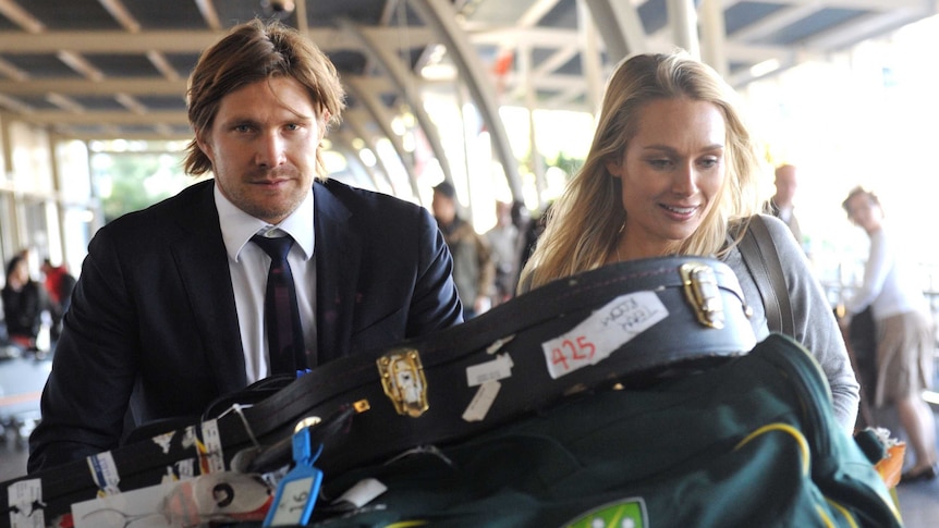 Australian cricket player Shane Watson and his wife Lee leave Sydney international airport.