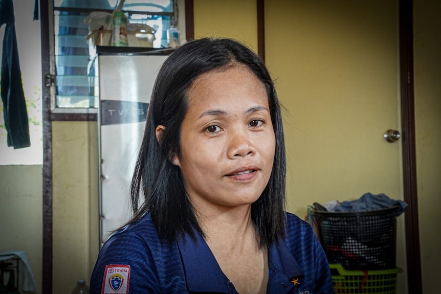 Thai woman wearing a blue shirt with medium-length hair.