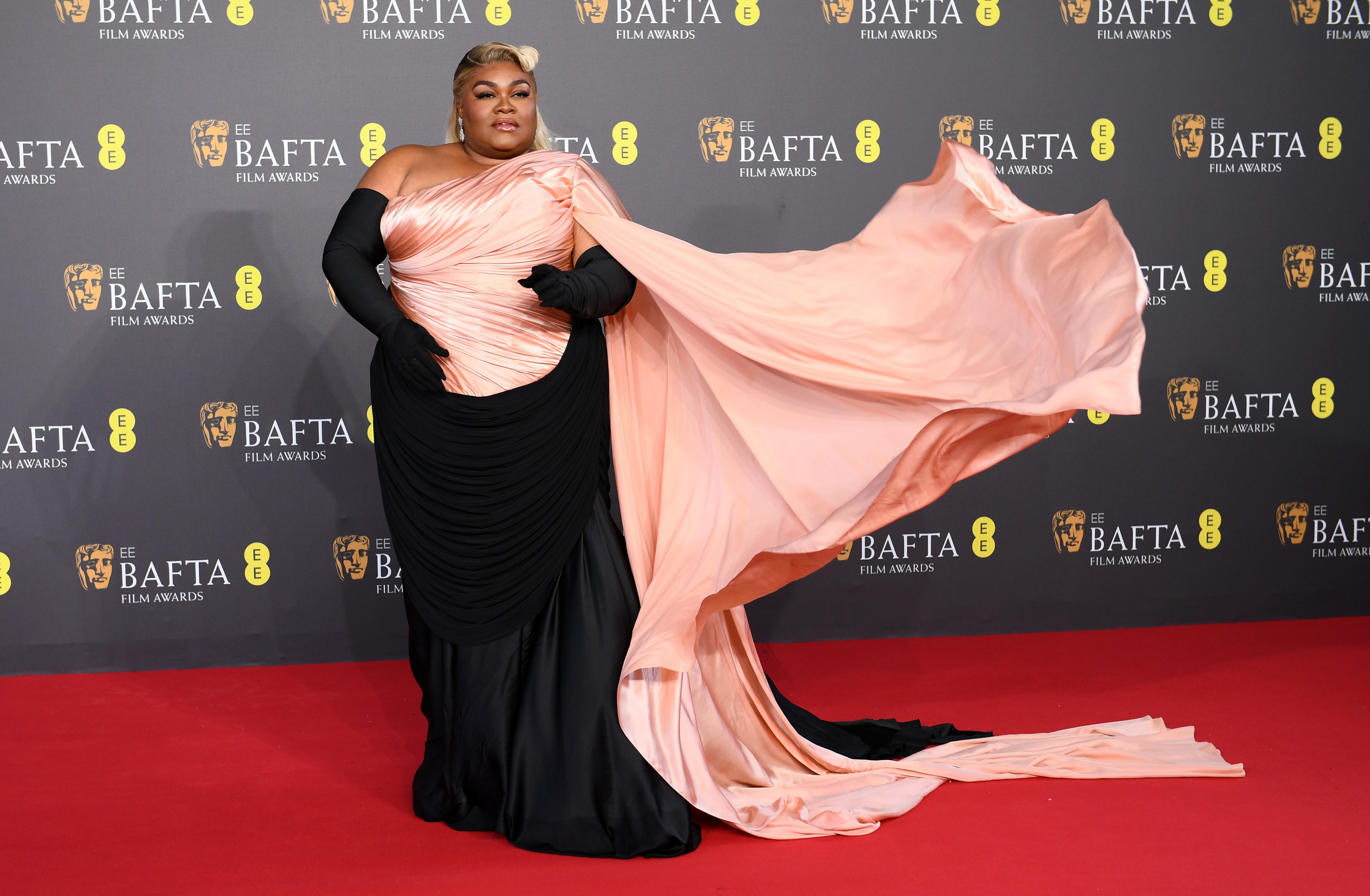 Da'Vine Joy Randolph on the red carpet wearing a peach and black dress