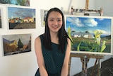 Shanshan Ai in front of her painting