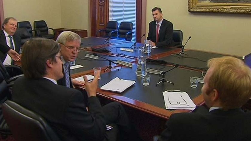 Justin Madden looks on as MPs argue before walking out.