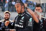Lewis Hamilton being fitted with his head piece before the Belgian Grand Prix