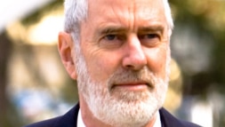 Ken Harvey, a man with white hair and beard, in a close-up shot