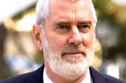 Ken Harvey, a man with white hair and beard, in a close-up shot