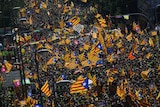 Thousands of people pack a street with independence flags on Catalan National Day.