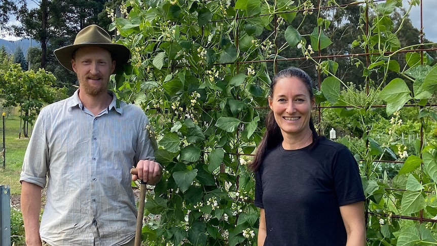 a man and a woman standing next to a health bean crop