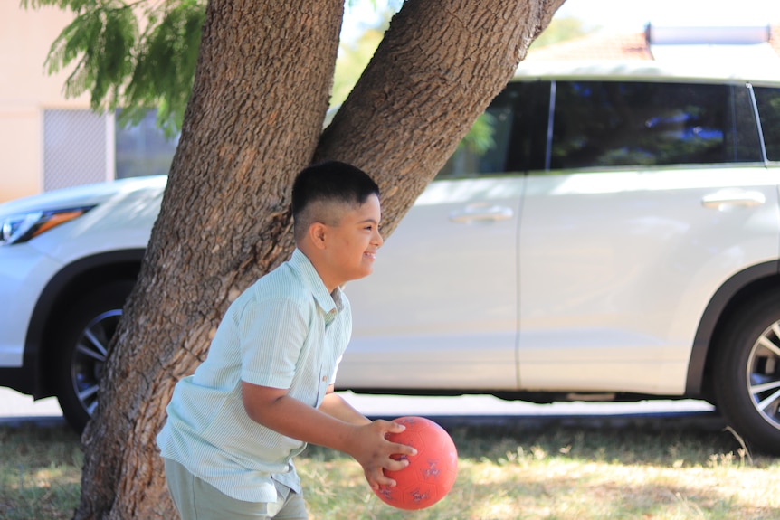 A boy plays with a ball 