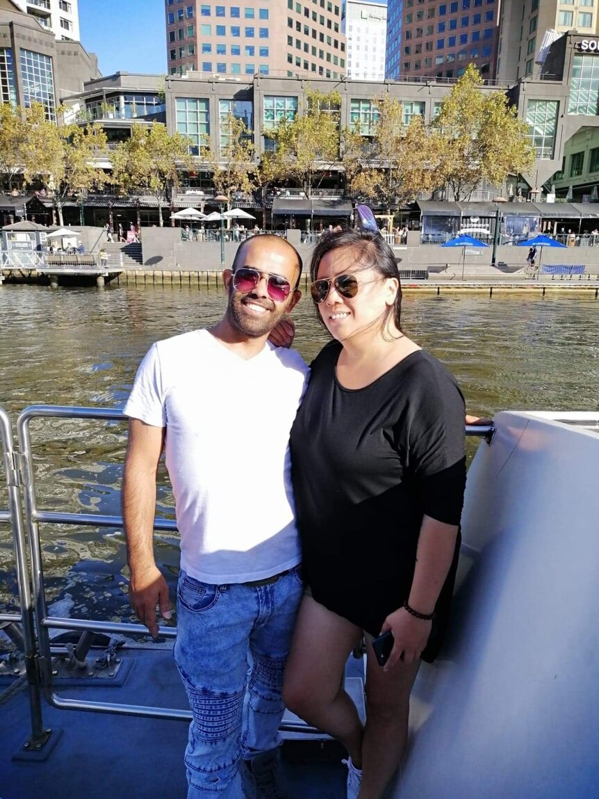 Photo of Ahmed and Danice on a ferry in Melbourne.