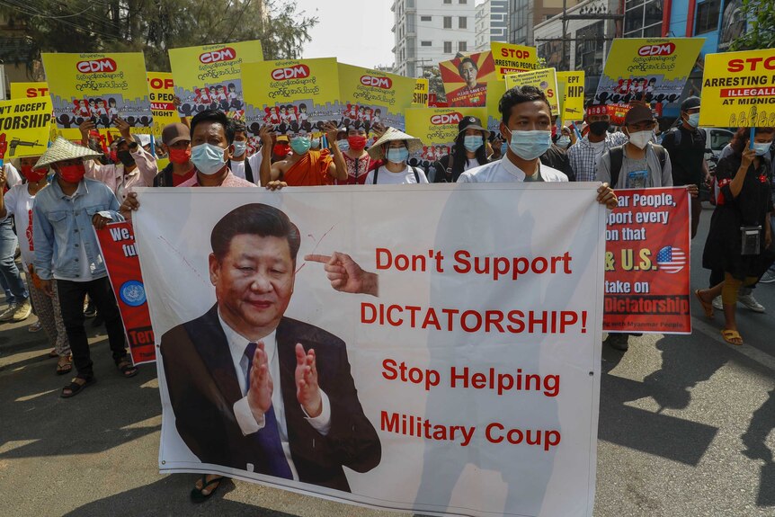 Demonstrators display a picture of Chinese president Xi Jinping