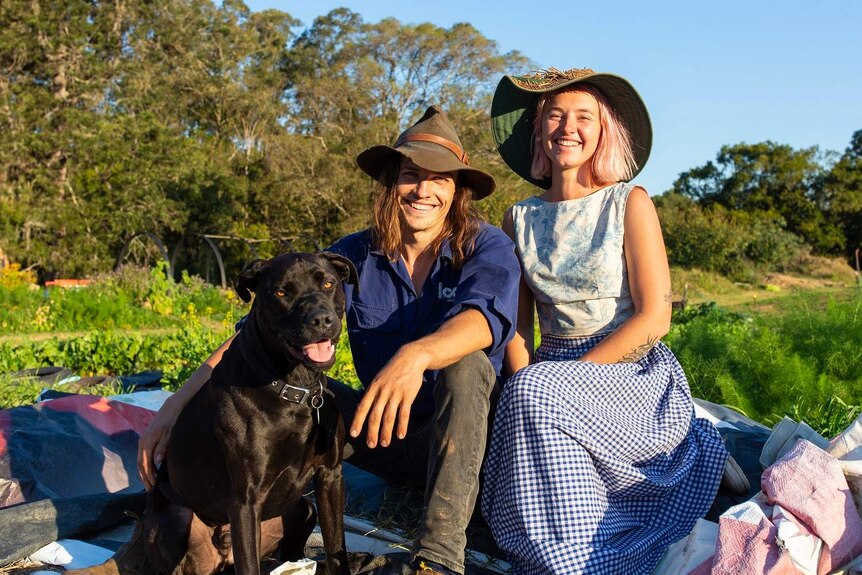 Phil, Alice and Derek the dog pose at their farm in Samford Valley, Queensland, taken on 24th July 2018