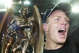 Penrith Panthers Luke Rooney and Luke Lewis hold the NRL premiership trophy after the 2003 grand final against the Roosters.