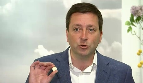 Matthew Guy holding a $2 coin