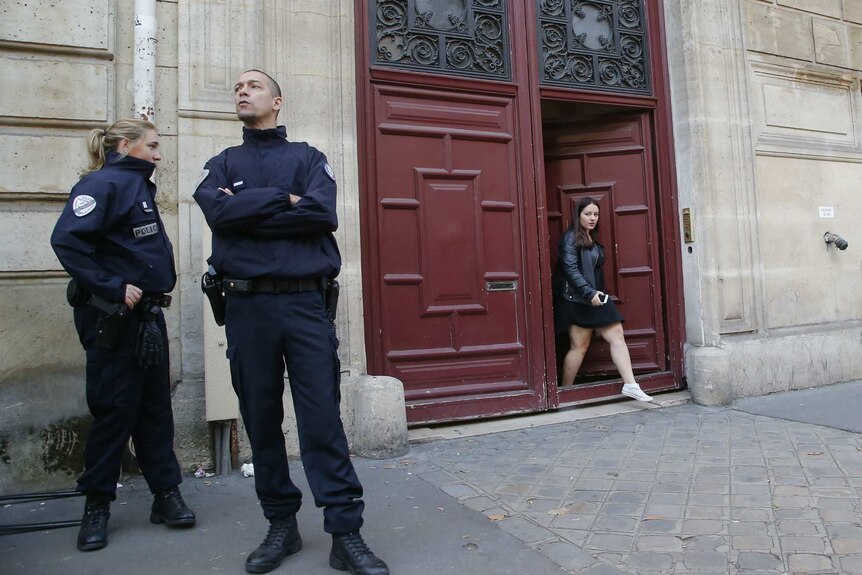 French police officers stand outside a building