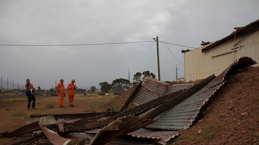 SES volunteers inspect storm damage to the century-old goods shed at the Golden Mile Loopline Railway.