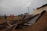 SES volunteers inspect storm damage to the century-old goods shed at the Golden Mile Loopline Railway.
