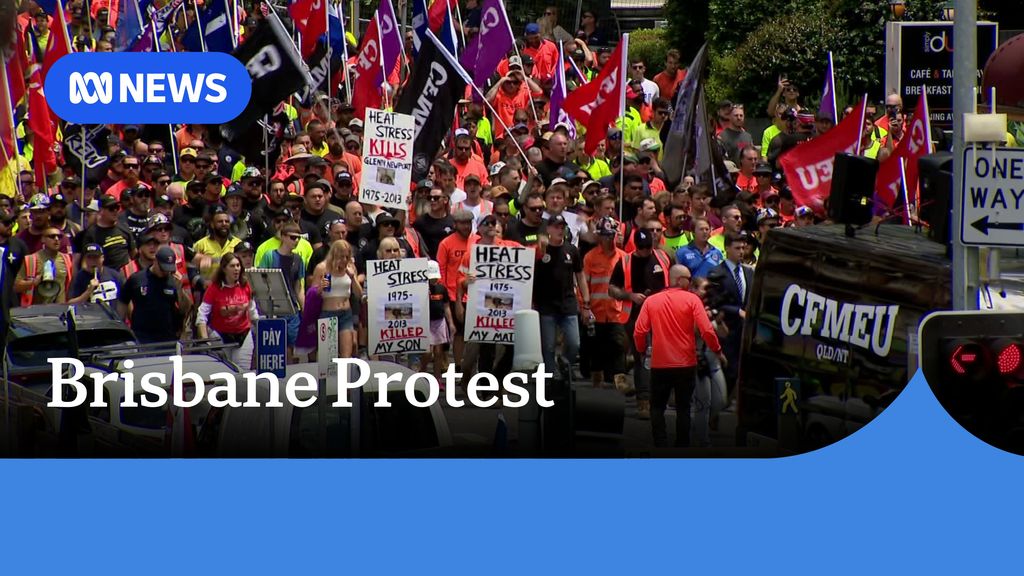 Brisbane Protest: Protesters march down a street holding CFMEU banners.