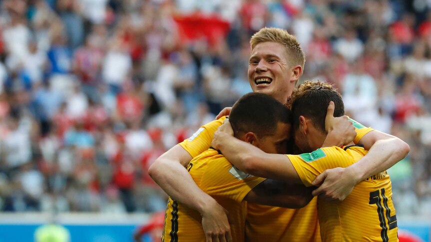 Belgium players hug to celebrate scoring