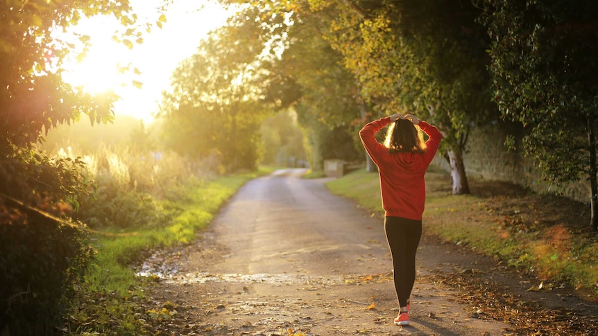 Woman exercising in the sunshine for story how sun exposure can help limit effects of jet lag