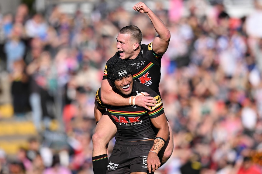 Two Penrith Panthers NRL players celebrate a try against the Canterbury Bulldogs.