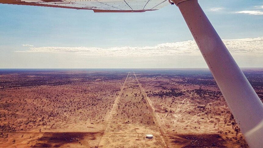 View from light aircraft over barren, flat desert