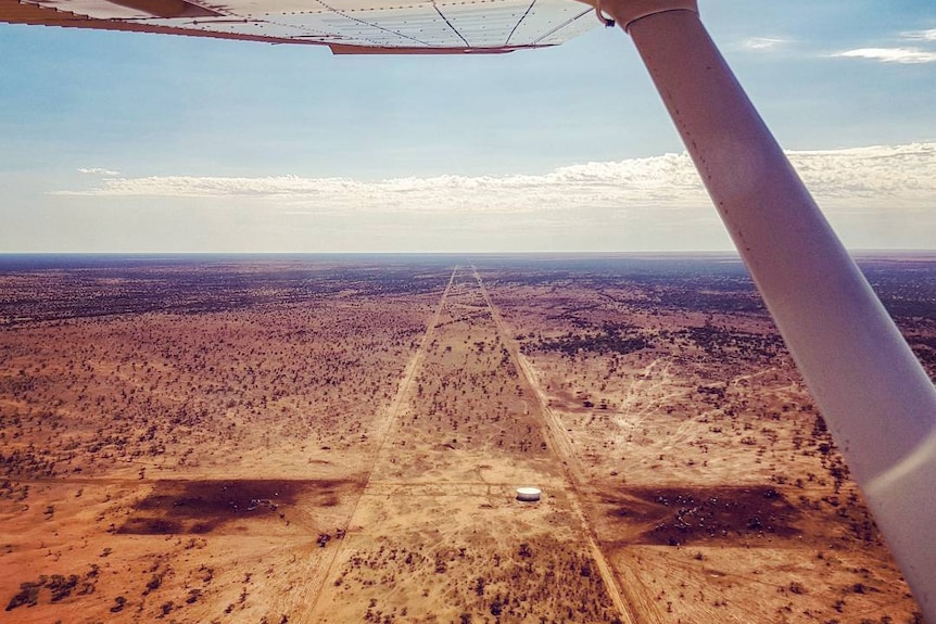 View from light aircraft over barren, flat desert