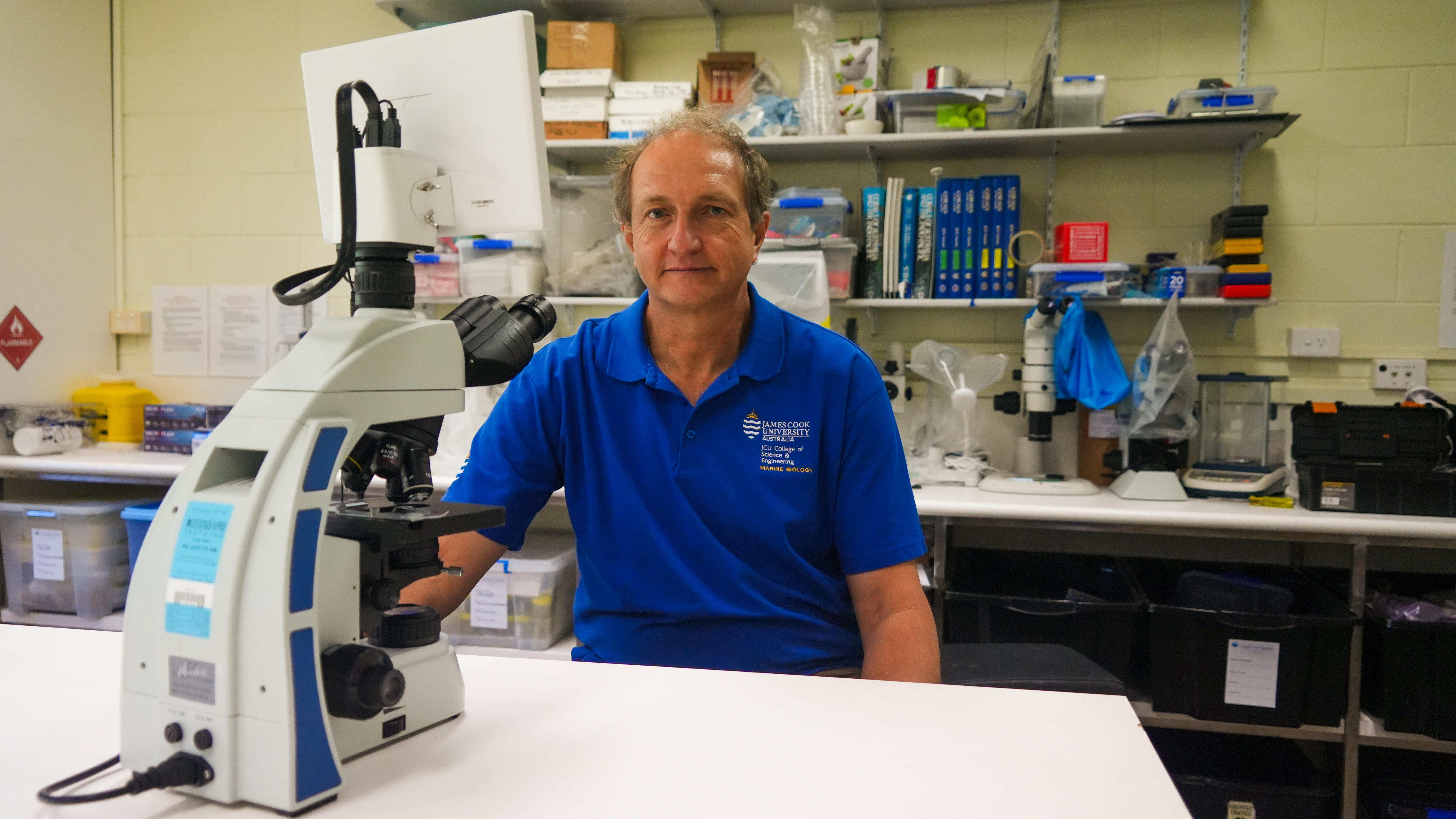 A man sitting at a microscope
