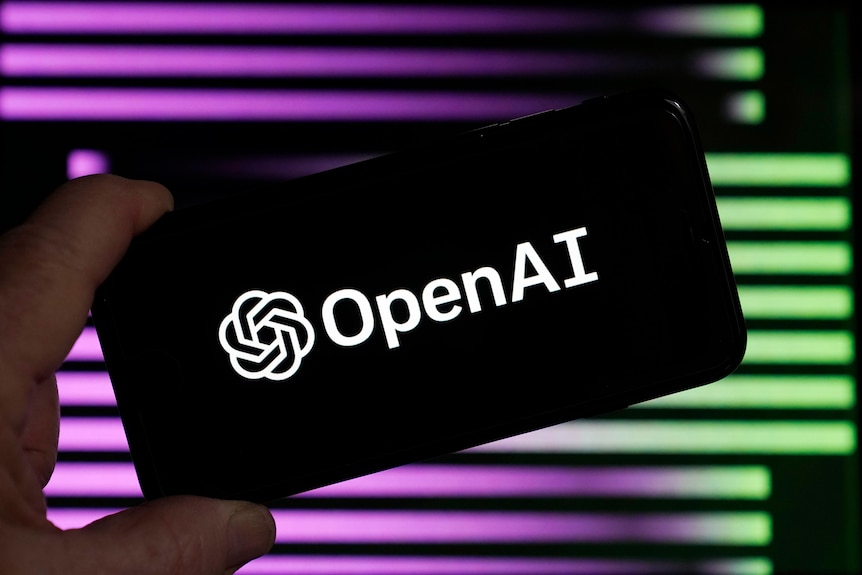 A smartphone says Open AI in front of a purple and green background. 