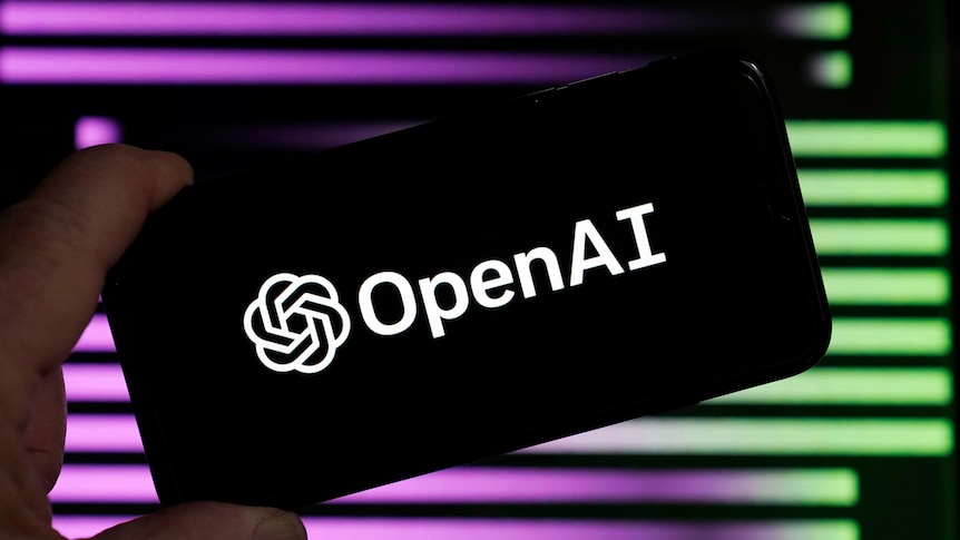 A smartphone says Open AI in front of a purple and green background. 