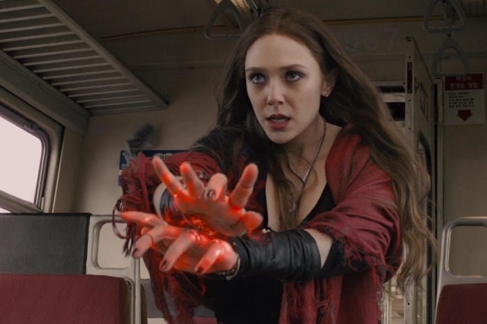 Wanda Maximoff glows red from her hands as she uses her powers.