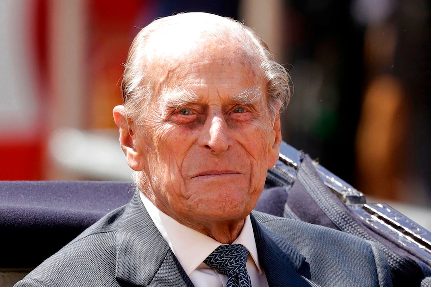 Prince Philip, the husband of Queen Elizabeth II, sits in a carriage in London.