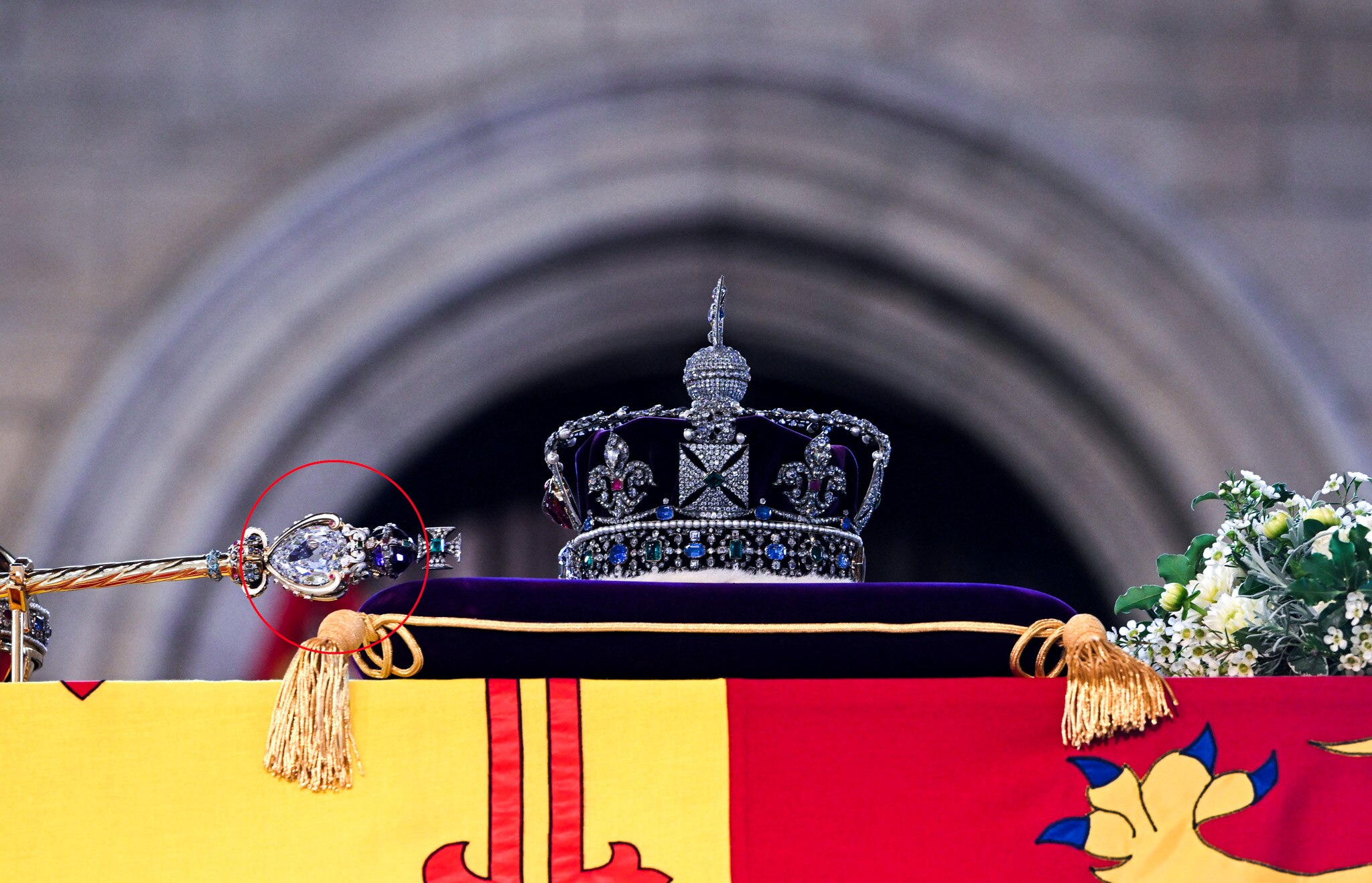 The royal sceptre lays face down on the Queen's coffin with a large diamond in the centre.