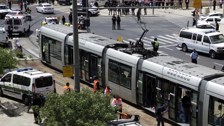 Emergency services attend to the scene of the stabbing attack on board a light rail train in Jerusalem on Friday.