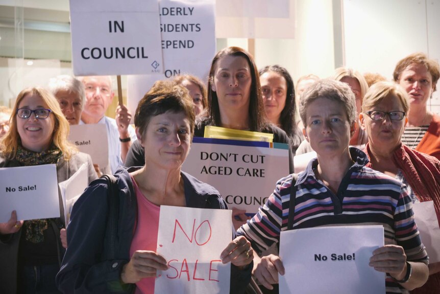 A group of protesters hold signs outside the Glen Eira council officers