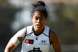 Mua Laloifi chases a ball for Carlton during an AFLW game.
