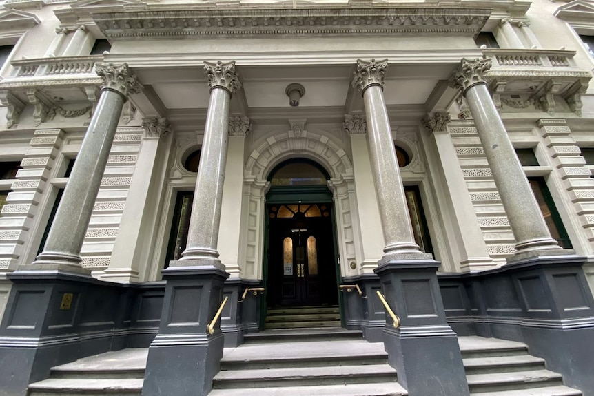 The exterior of a grand-looking Victorian-era building showing the club's front doors.