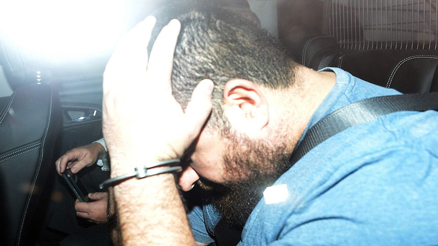 Omar Succarieh in a police car.
