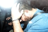 Omar Succarieh in a police car.