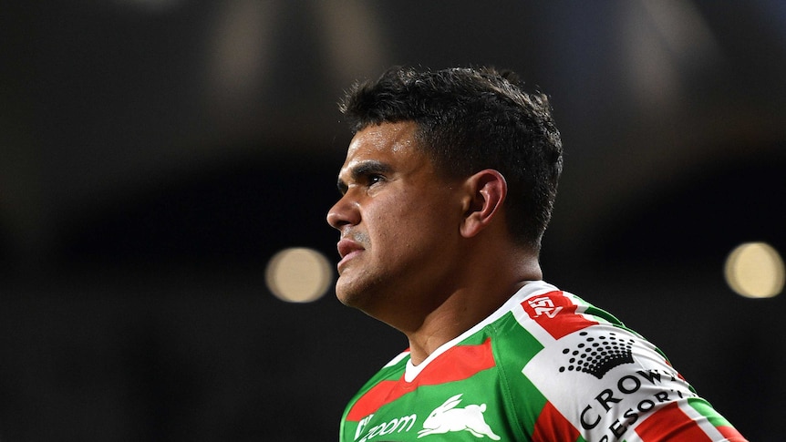 An Indigenous NRL player, in profile, grimacing as he looks off into the distance.