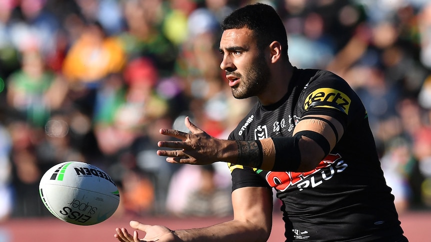 Tyrone May of the Penrith Panthers passes a ball.