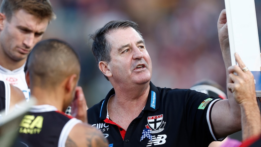 Ross Lyon points to a board during a break in an AFL match between St Kilda and Hawthorn.