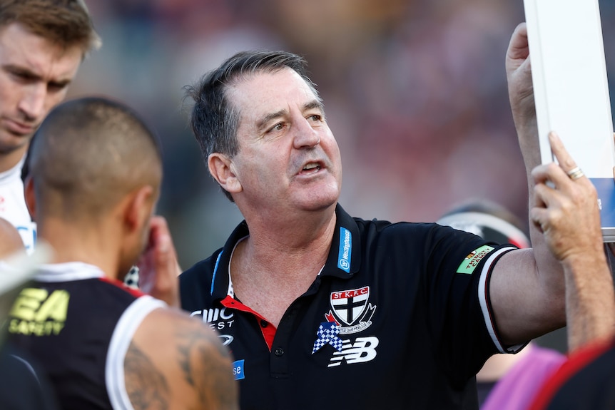 Ross Lyon points to a board during a break in an AFL match between St Kilda and Hawthorn.