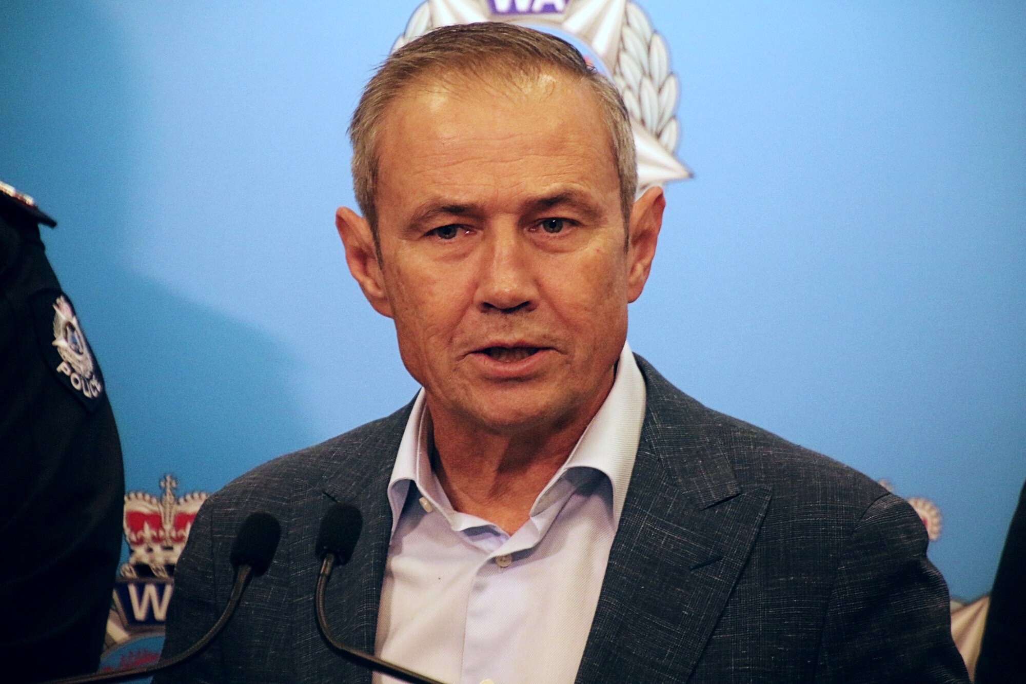 The Premier attends a media conference at a police building