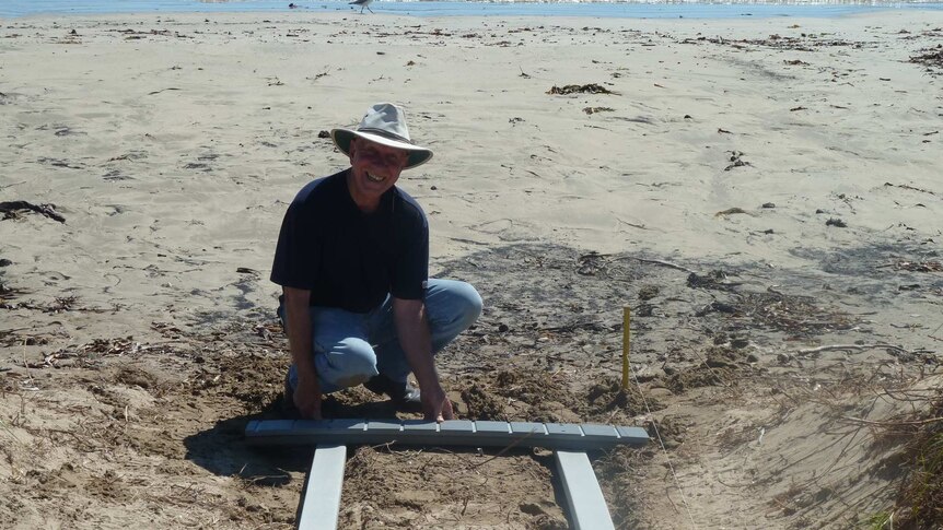 Bert Meyer begins to build a boardwalk made of recycled plastic to allow wheelchair access to a Eurobodalla beach