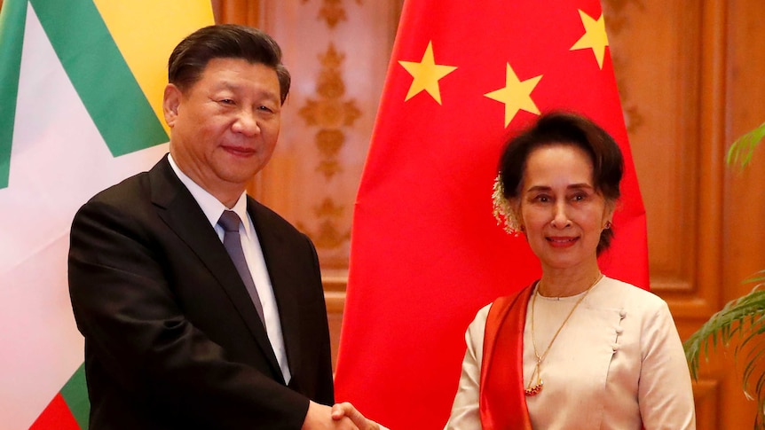 Myanmar State Counselor Aung San Suu Kyi, right, greets Chinese President Xi Jinping.