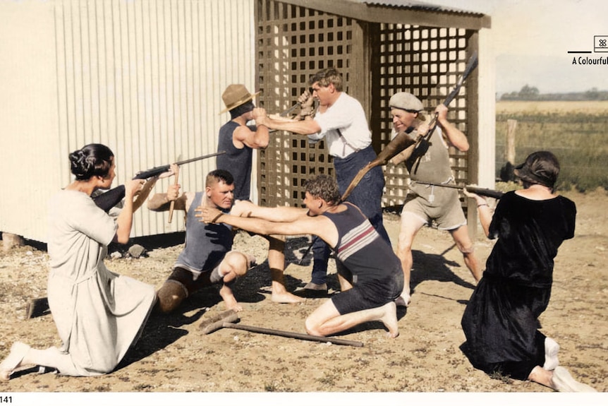 people play fighting in a photograph taken at a beach in 1925