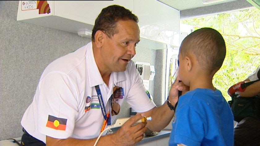 Qld health worker treating Indigenous child from mobile health unit van on December 8, 2008.