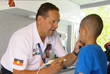 A Queensland Health worker treats a Indigenous child in a mobile health unit van on December 8, 2008.
