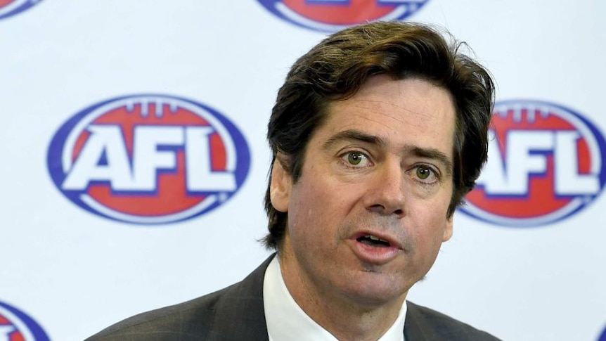 AFL CEO Gillon McLachlan speaking with the AFL logo in the background.