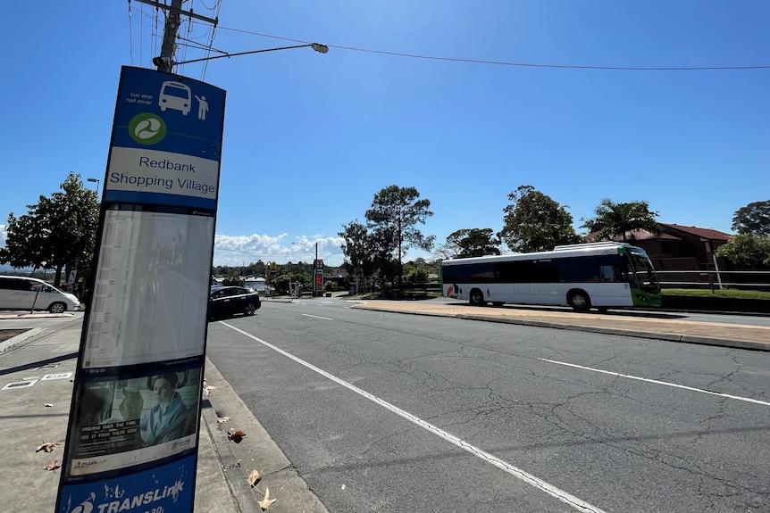 A bus stop in Redbank Plains with a bus driving past