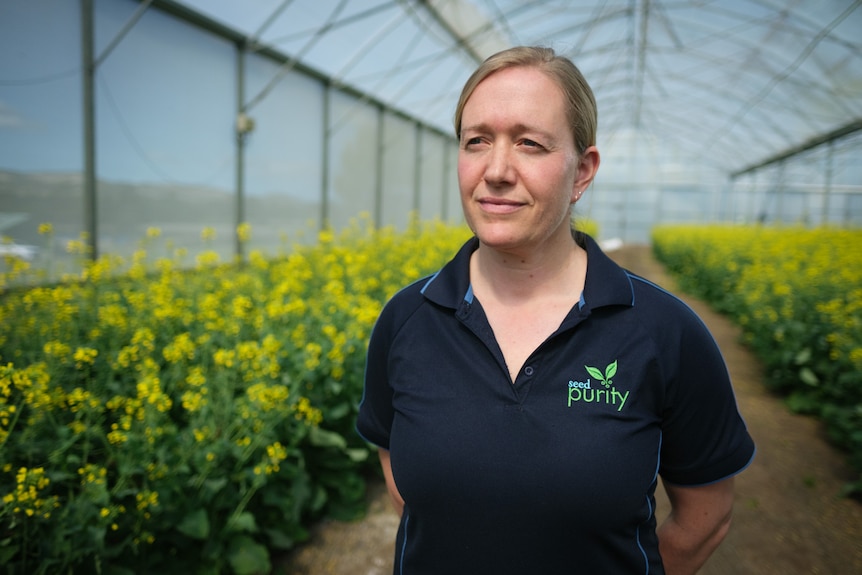 Dr Raylea Rowbottom stands inside a greenhouse.